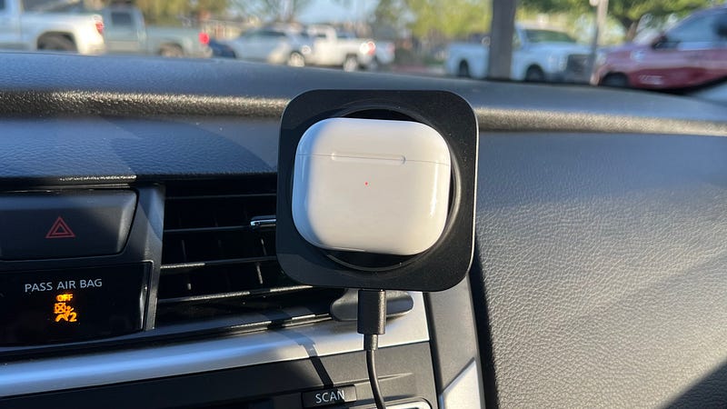 A phone mounted on a MagSafe charger in a car