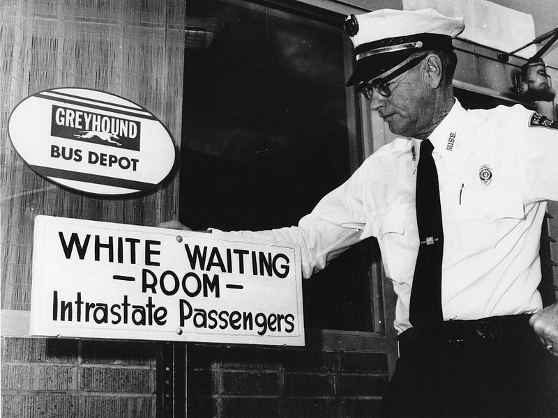 Historical image depicting segregation at a transportation hub.